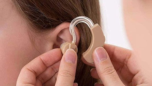 Close-up of person wearing tdtf1g-rd ultra superior sound hearing aid behind the ear